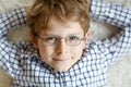 Close-up portrait of little blond kid boy with brown eyeglasses Royalty Free Stock Photo