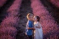 Close-up portrait of little boy kissing girl on the cheek in purple lavender field. Cute couple Royalty Free Stock Photo