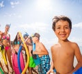 Portrait of a boy with friends on the beach Royalty Free Stock Photo