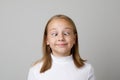 Close up portrait of a little girl crossing her eyes on white background Royalty Free Stock Photo