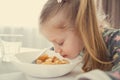 Close-up portrait of little girl with dinner