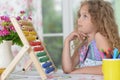 Little girl drawing a book at the table Royalty Free Stock Photo