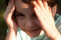 Close-up portrait of a little girl with her hands covering her eyes. Photo at golden hour Royalty Free Stock Photo