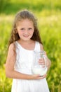 Close up portrait little girl holding pitcher of milk outdoor summer Royalty Free Stock Photo