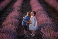 Close-up portrait of little girl kissing boy on cheek in purple lavender field. Loving cute couple Royalty Free Stock Photo