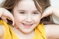 The close up portrait of little girl`s face with missing front lower milk teeth in a smiling mouth Royalty Free Stock Photo