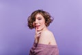 Close-up portrait of lovable short-haired girl with pale skin posing on purple background. Indoor photo of gorgeous