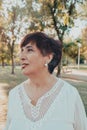 Close up portrait of lovely hispanic middle aged woman in the park Royalty Free Stock Photo