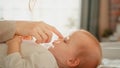 Close Up Portrait of a Loving Young Beautiful Mother Playing and Soothing Adorable Baby in Bed Royalty Free Stock Photo