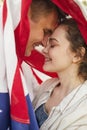 Affectionate Young Couple Under American Flag Royalty Free Stock Photo