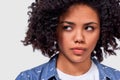 Close-up portrait of mad young African American woman has sad facial expression, wears casual outfit, isolated over white studio Royalty Free Stock Photo