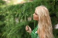 Close-up portrait of magnificent caucasian blond girl with natural makeup and long healthy wavy hair. Lovable long-haired blonde