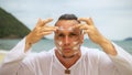 Close-up portrait man apply sun cream protection lotion. Funny men on beach near sea smearing sunscreen cream in style Royalty Free Stock Photo