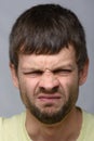 Close-up portrait of a man with an emotion of disgust, European appearance