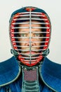 Close up portrait of man in kendo helmet, kendoka studio shot on white. Royalty Free Stock Photo