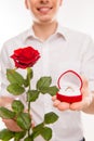 Close up portrait of man with rose and wedding ring going to make proposal