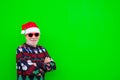 Close up and portrait of mature and old man or senior smiling and looking at the camera wearing christmas clothes and hat with Royalty Free Stock Photo