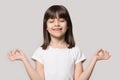 Close up portrait with meditator little brown-haired girl.