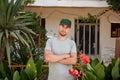 Close-up portrait Middle-aged man working at the house, Gardener near Calathea Lutea Plant Royalty Free Stock Photo