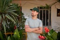 Close-up portrait Middle-aged man working at the house, Gardener near Calathea Lutea Plant Royalty Free Stock Photo