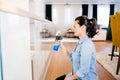 Portrait of modern woman doing housework around the house. Woman cleaning glass with detergent and cloth Royalty Free Stock Photo