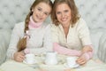 Close up portrait of mother and daughter drinking tea Royalty Free Stock Photo