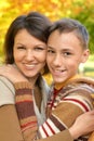 Close up portrait of mother with son hugging outoors