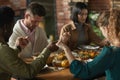 People Praying at Dinner