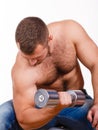 Close-up portrait of Muscular guy doing exercises with dumbbells over white background Royalty Free Stock Photo