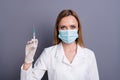 Close-up portrait of nice attractive blonde girl qualified experienced doc specialist expert holding in hands syringe Royalty Free Stock Photo