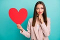 Close-up portrait of nice attractive charming peaceful straight-haired girl holding in hand big large heart medicine Royalty Free Stock Photo