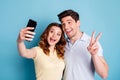 Close-up portrait of nice attractive cheerful cheery glad positive people taking making selfie showing v-sign isolated Royalty Free Stock Photo