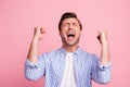 Close-up portrait of nice attractive handsome cheerful cheery guy wearing checked shirt best luck holding fists enjoying