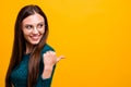 Close-up portrait of nice attractive knowledgeable cheerful straight-haired girl wearing green sweater showing aside Royalty Free Stock Photo