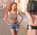 Beautiful brown curly hair woman posing in city Royalty Free Stock Photo