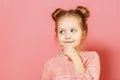 Close-up portrait of nice lovely attractive fascinating winsome little child girl with buns looking thoughtful up aside. Royalty Free Stock Photo