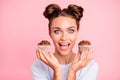Close-up portrait of nice lovely exquisite attractive funny cheerful positive crazy girl holding in hands two cakes