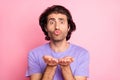 Close up portrait of nice young person kiss you sending air arms violet clothing isolated on pastel pink color Royalty Free Stock Photo