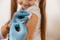 Close-up portrait. A health worker gives a child a girl a coronavirus vaccination Royalty Free Stock Photo