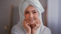 Close up portrait old middle-aged mature senior Caucasian smiling woman face lady in bath robe with towel on head with Royalty Free Stock Photo