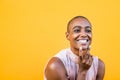 Close up and portrait of one young and beautiful afro American woman looking at the camera smiling and opening her eyes - cheerful Royalty Free Stock Photo