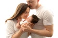 Close up portrait of parents. Father and mother kiss beautiful newborn daughter Royalty Free Stock Photo