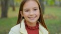 Close up portrait in park autumn alone one beautiful adorable adopted cute teen schoolgirl smiling happy positive Royalty Free Stock Photo