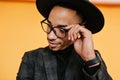 Close-up portrait of pensive african guy in black wristwatch. Indoor photo of mulatto young man posing with dreamy face