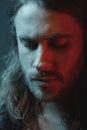 Close-up portrait of pensive bearded long haired man