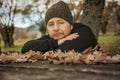 Close up portrait pensive man with sitting on a bench. Autumn le Royalty Free Stock Photo