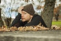 Close up portrait pensive man with wool hat sitting on a bench. Royalty Free Stock Photo