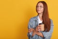 Close up portrait of pensive woman with dark hair, looking aside, contemplates about something, wearing white t shirt, denim Royalty Free Stock Photo