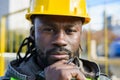 close-up portrait of pensive young black engineer man looking at camera outdoors Royalty Free Stock Photo