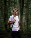 close up portrait photography of a young photographer guy with camera on a neck strap in a forest Royalty Free Stock Photo